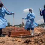 Health workers at a grave side in DRC