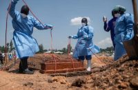 Health workers at a grave side in DRC
